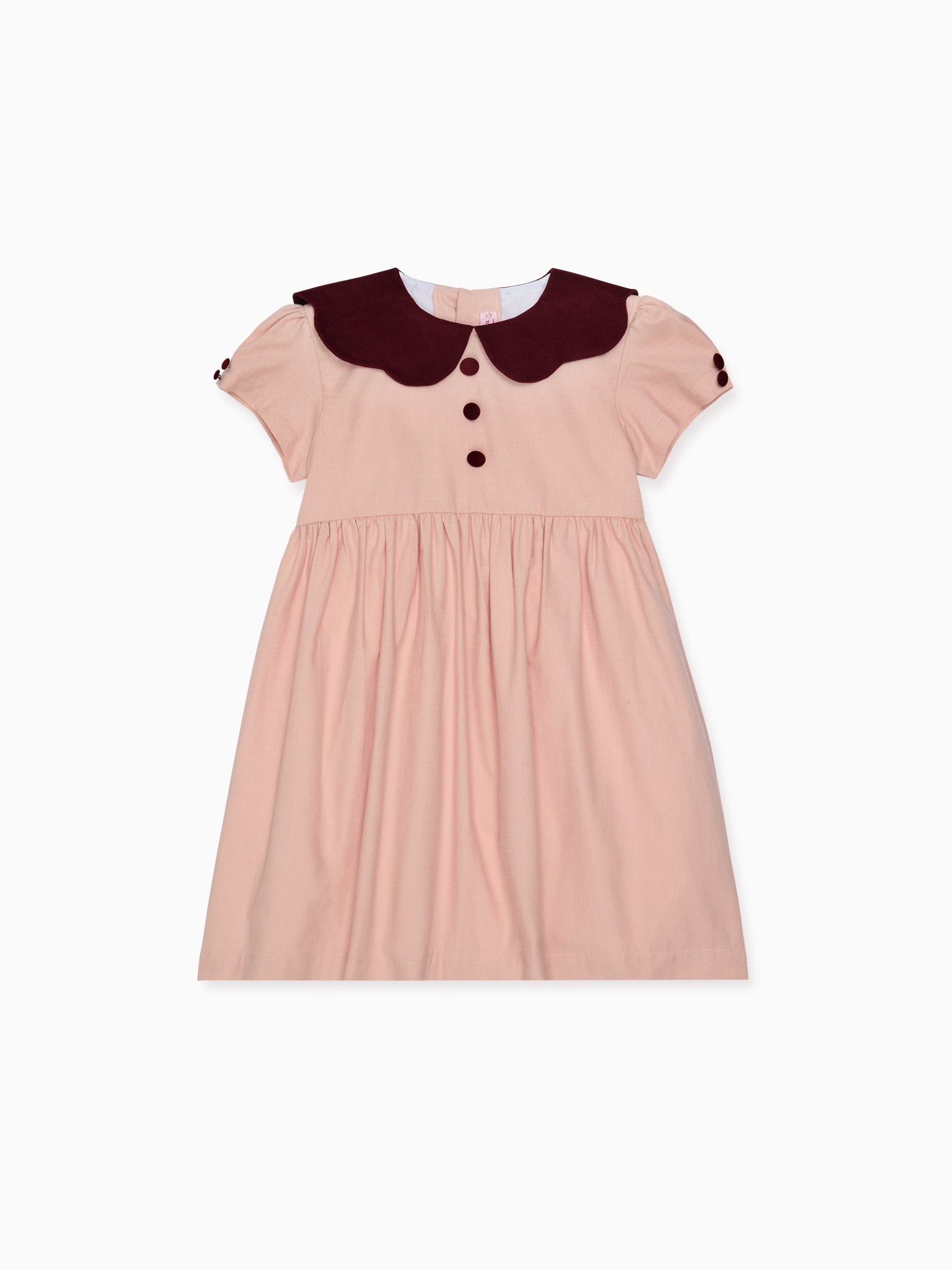 Elegant children's dress, showcasing soft pink fabric with deep burgundy Peter Pan collar and buttons; perfect for special occasions.