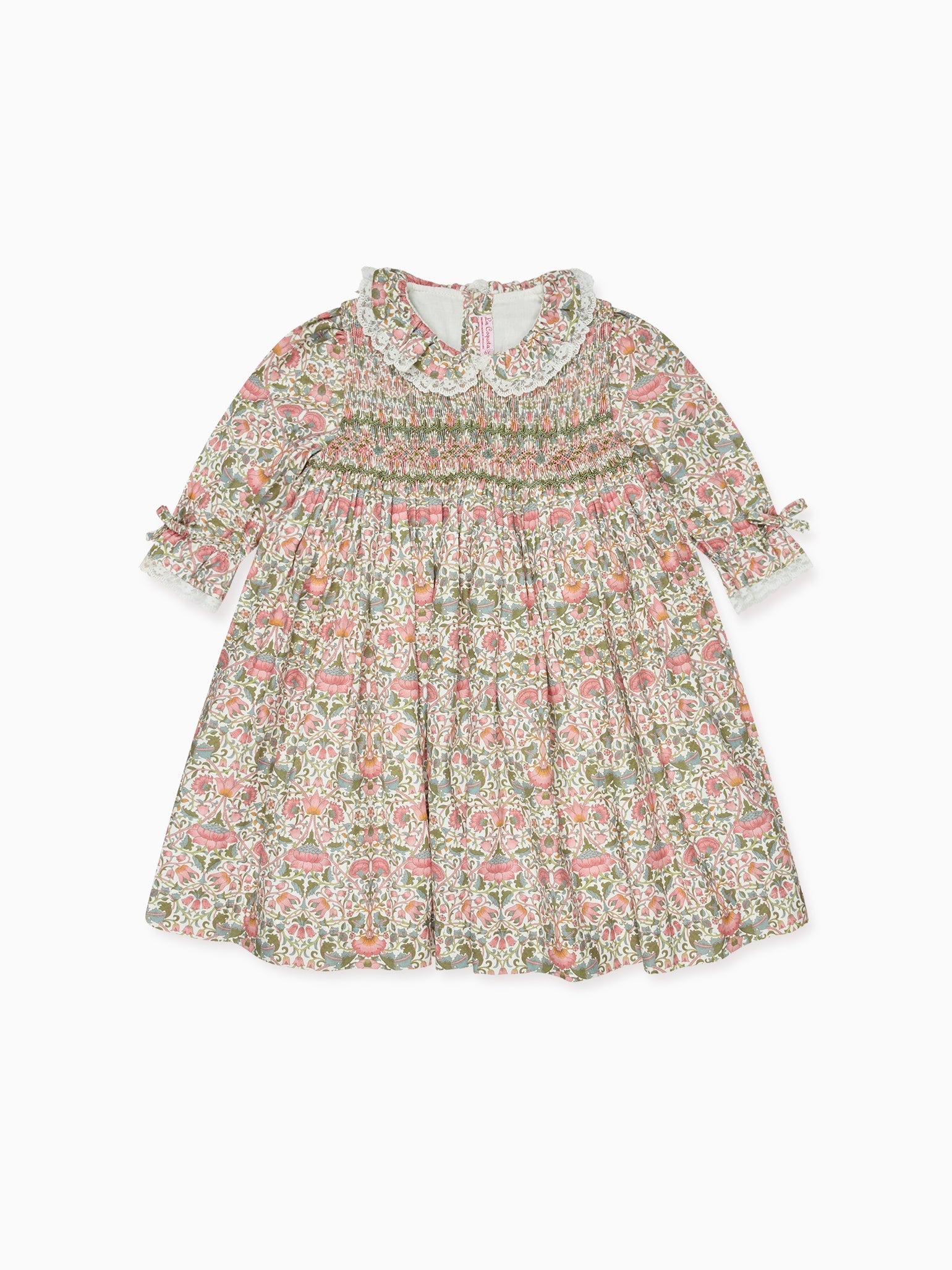 Elegant children's dress with intricate floral pattern, smocked bodice, lace collar, and bow-tied sleeves, perfect for special occasions.