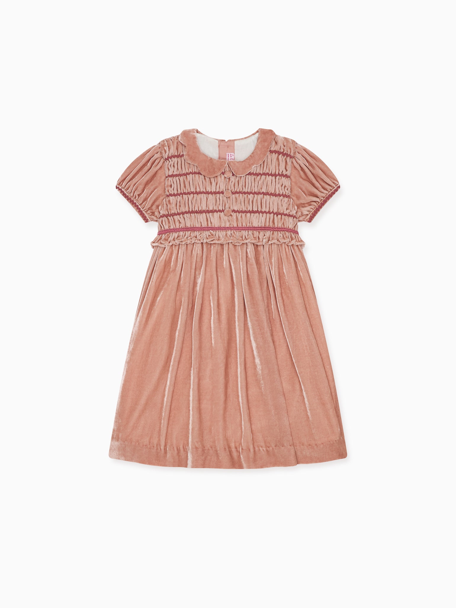 Luxurious children's dress in soft pink velvet fabric featuring short sleeves, intricate smocking, and classic Peter Pan collar.