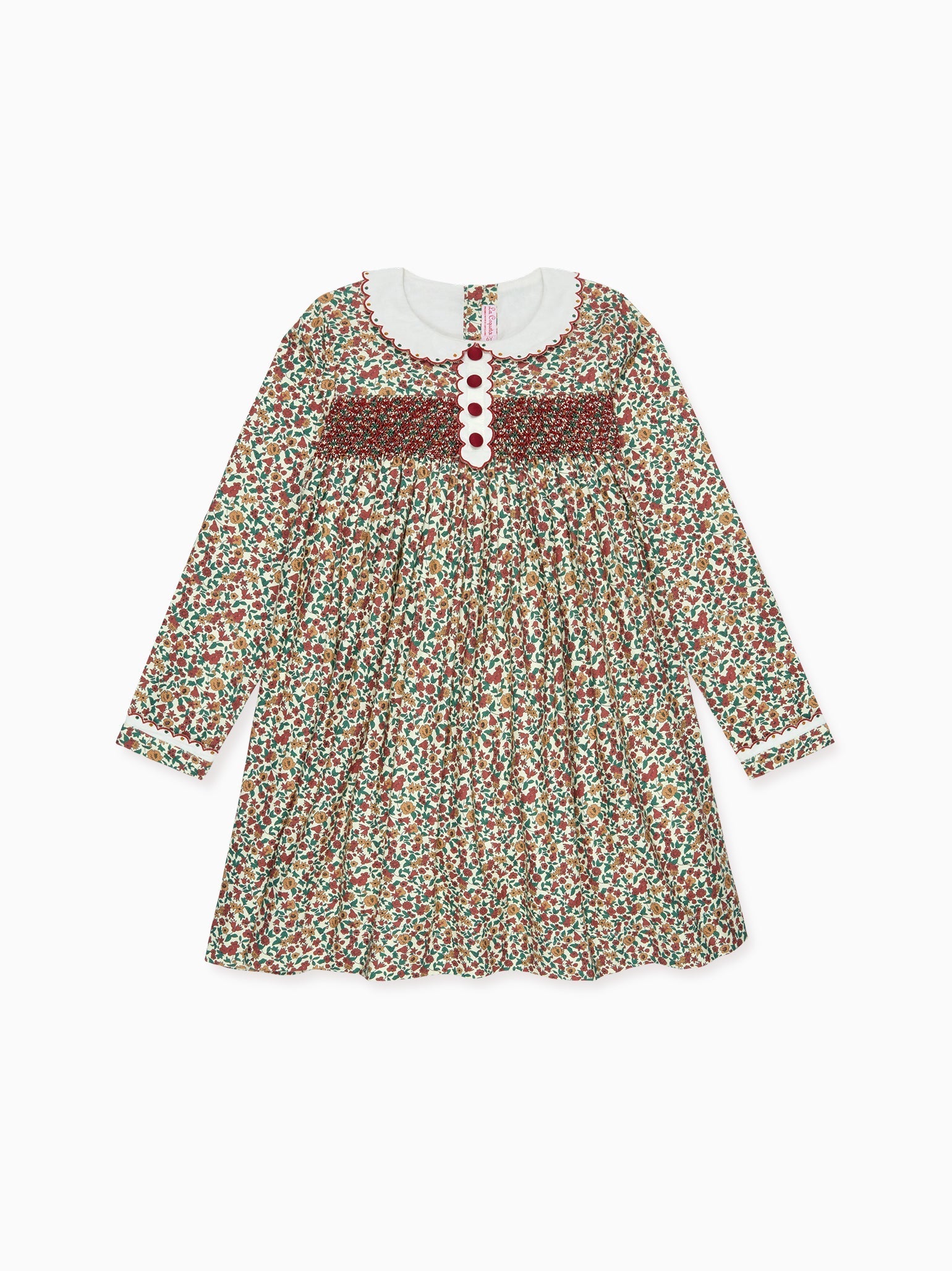 A charming floral patterned children's dress in vibrant red, green, and brown hues, featuring a white Peter Pan collar.