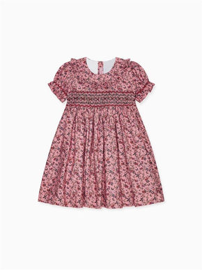 Elegant pink floral child's dress with short ruffled sleeves and smocked bodice, perfect for special occasions.