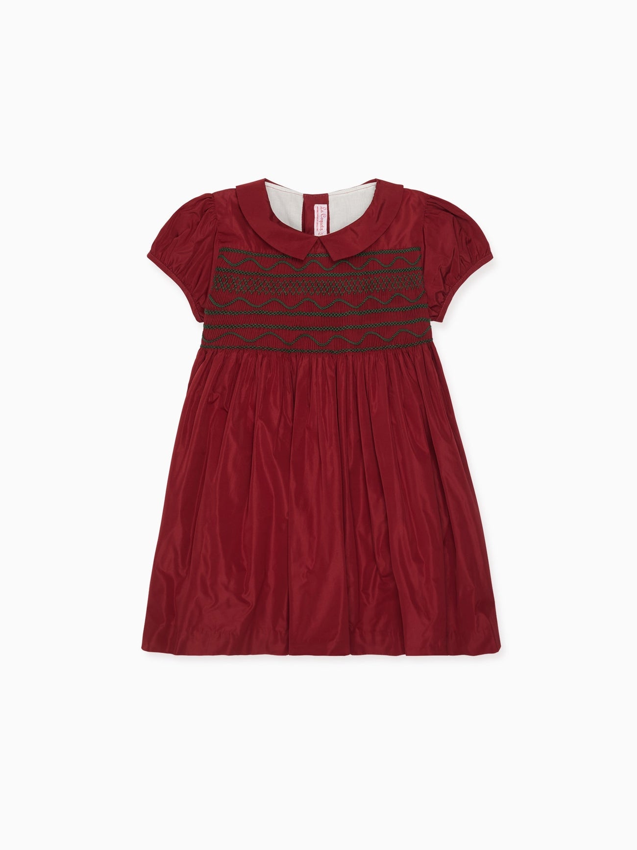 Elegant children's dress in rich red cotton with short sleeves, Peter Pan collar, and intricate smocked bodice, perfect for special occasions.