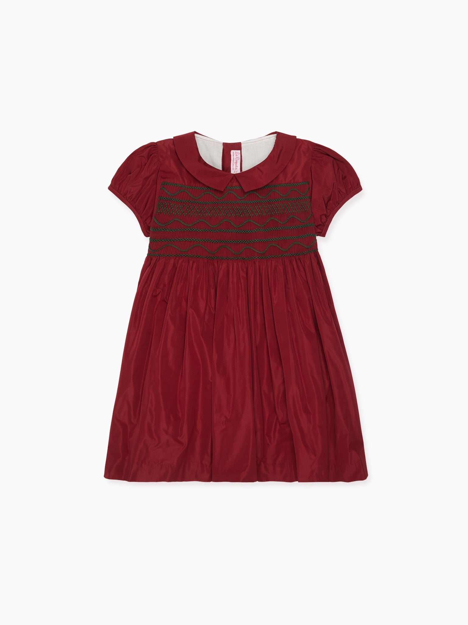 Elegant children's dress in rich red cotton with short sleeves, Peter Pan collar, and intricate smocked bodice, perfect for special occasions.